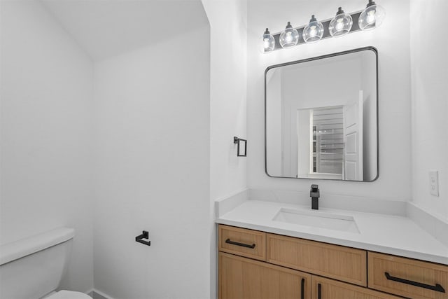 half bathroom with vanity and toilet