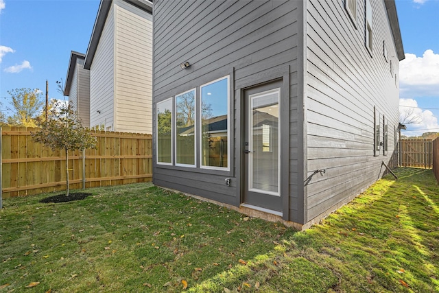 view of home's exterior featuring a lawn and a fenced backyard