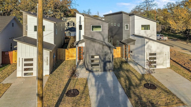 view of front of house featuring fence and a gate