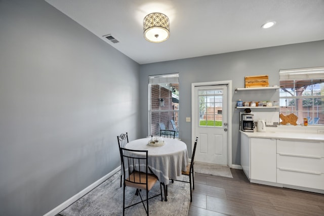 dining space with recessed lighting, baseboards, visible vents, and wood finished floors