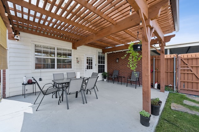 view of patio with a gate, fence, a pergola, and outdoor dining space