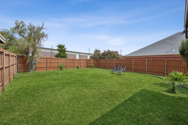 view of yard with a fenced backyard