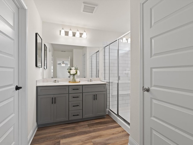 3601 Keechi Creek Dr, Celina, TX 75078 - full bath with a stall shower, double vanity, visible vents, and wood finished floors