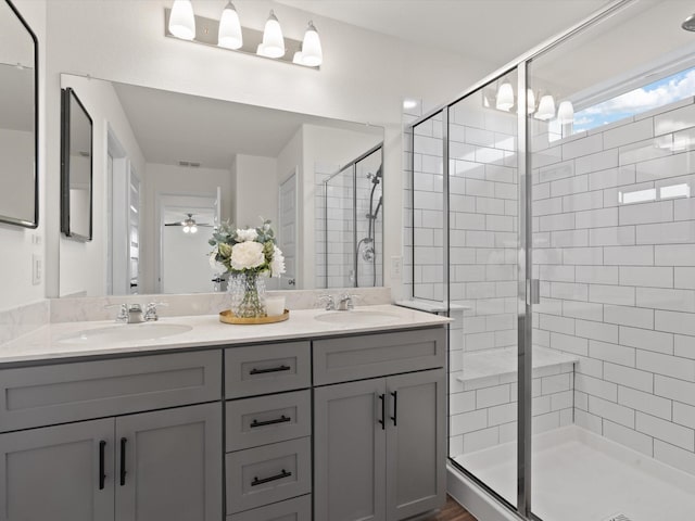 3601 Keechi Creek Dr, Celina, TX 75078 - bathroom featuring double vanity, a ceiling fan, a stall shower, and a sink