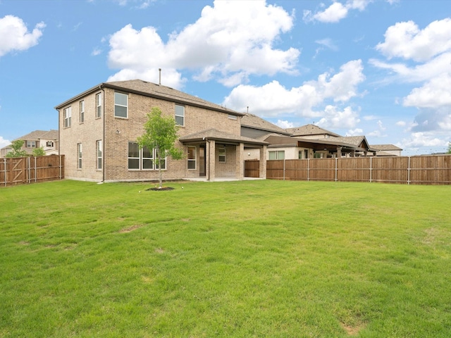 3601 Keechi Creek Dr, Celina, TX 75078 - back of property featuring a yard, a patio area, brick siding, and a fenced backyard