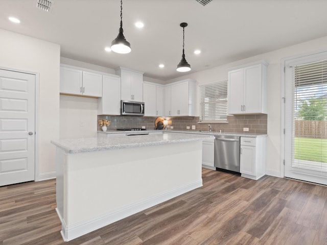 3601 Keechi Creek Dr, Celina, TX 75078 - kitchen featuring white cabinetry, a healthy amount of sunlight, and appliances with stainless steel finishes