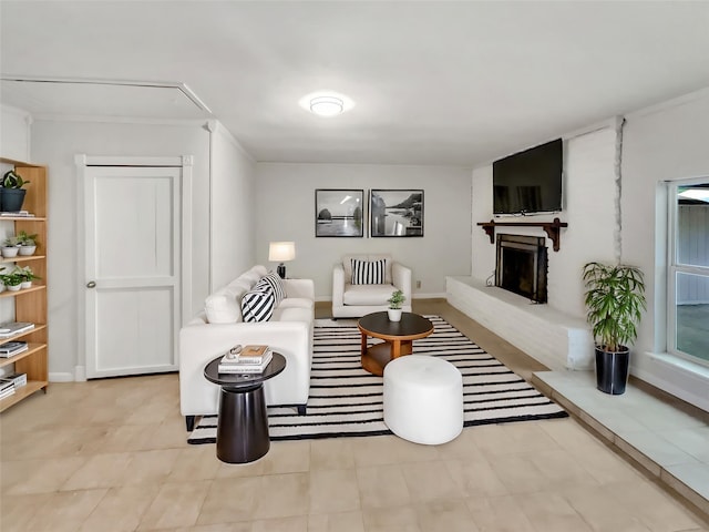 living area with a fireplace with raised hearth and baseboards