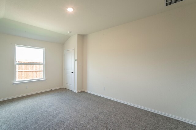 carpeted spare room with baseboards, lofted ceiling, recessed lighting, and visible vents