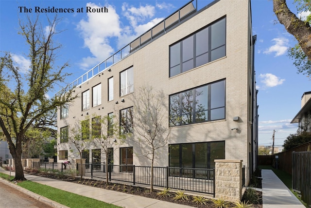 view of building exterior featuring fence
