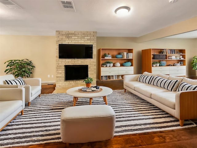 living area featuring a fireplace and visible vents