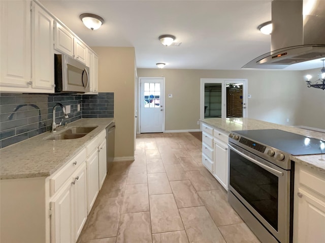 kitchen featuring decorative backsplash, a sink, ventilation hood, stainless steel appliances, and white cabinetry