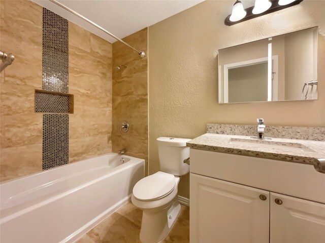 full bath featuring washtub / shower combination, a textured wall, vanity, and toilet