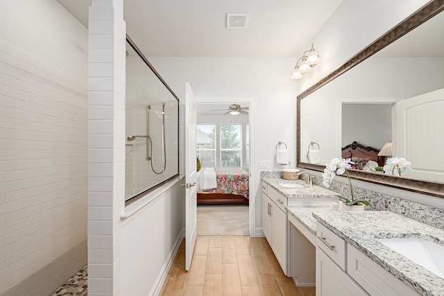 full bathroom featuring connected bathroom, double vanity, walk in shower, and a sink