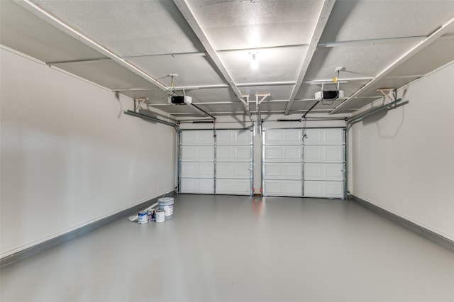 garage with baseboards and a garage door opener