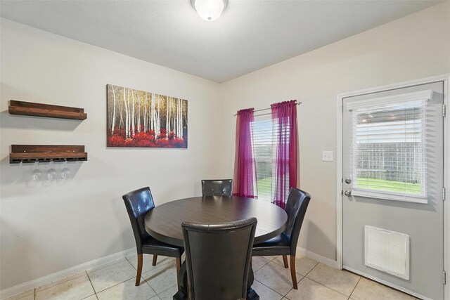 dining room with plenty of natural light, baseboards, and light tile patterned floors