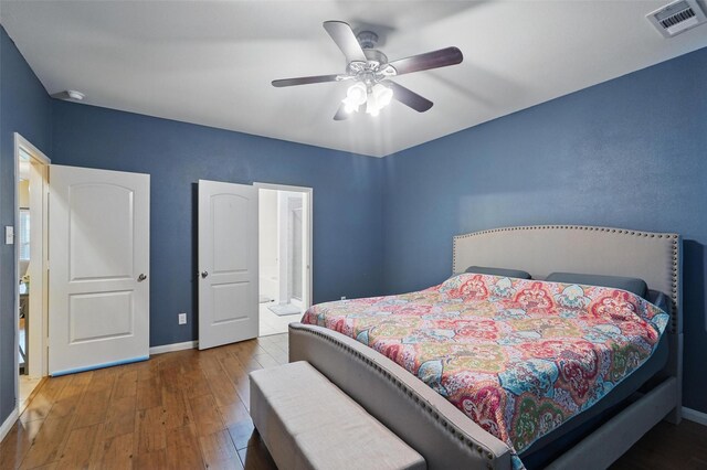 bedroom featuring wood finished floors, baseboards, and ceiling fan