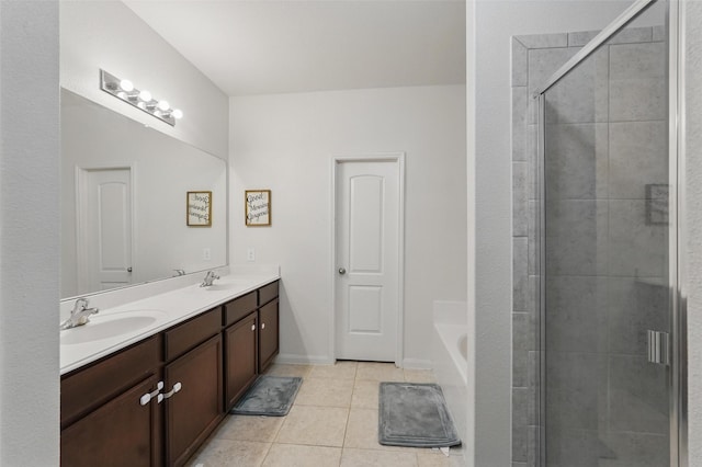full bath with tile patterned flooring, a stall shower, double vanity, and a garden tub