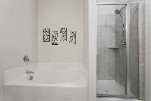 full bath with a stall shower and a garden tub