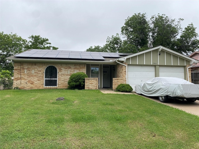 2406 Parkside Dr, Grand Prairie, TX 75052 - ranch-style house with a garage, solar panels, brick siding, and a front yard