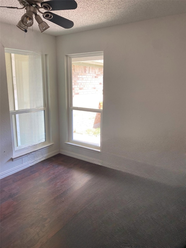 2406 Parkside Dr, Grand Prairie, TX 75052 - empty room with baseboards, a ceiling fan, dark wood-style flooring, and a textured ceiling