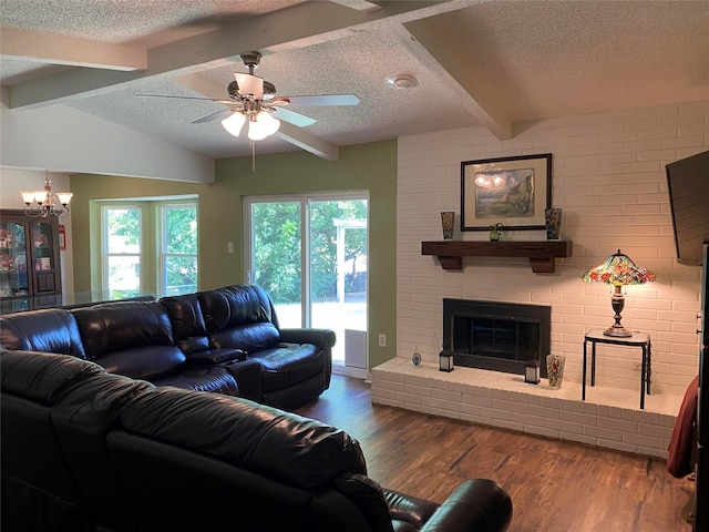 2406 Parkside Dr, Grand Prairie, TX 75052 - living area featuring a textured ceiling, a fireplace, wood finished floors, lofted ceiling with beams, and ceiling fan with notable chandelier