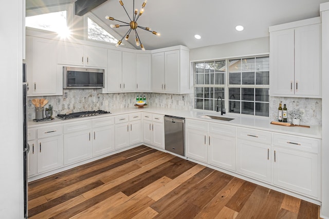 3005 Macao Ct, Plano, TX 75075 - kitchen featuring dark wood-style floors, light countertops, white cabinets, a sink, and appliances with stainless steel finishes