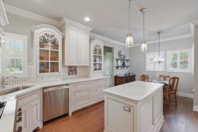 kitchen featuring a notable chandelier, a sink, dishwasher, light countertops, and decorative light fixtures