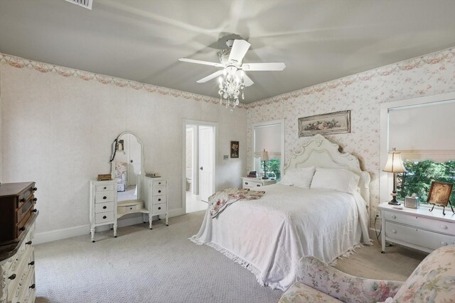 carpeted bedroom with ceiling fan and wallpapered walls