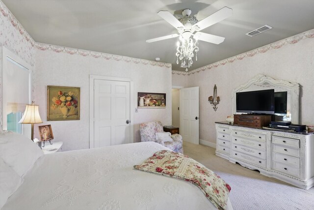 bedroom featuring ceiling fan, light carpet, and visible vents