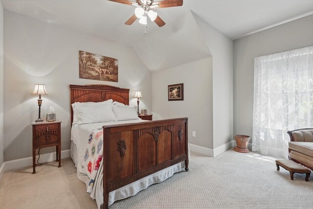 bedroom with light colored carpet, a ceiling fan, baseboards, and lofted ceiling