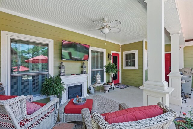 exterior space with a ceiling fan and an outdoor living space with a fireplace