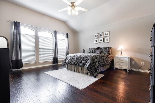 bedroom with baseboards, ceiling fan, wood finished floors, and lofted ceiling