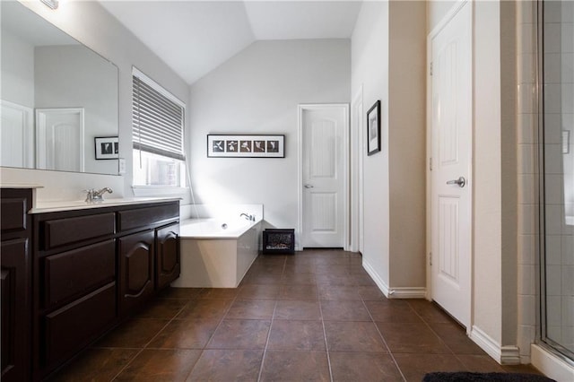 bathroom with vanity, a stall shower, a bath, and lofted ceiling