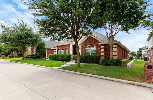view of front of house with brick siding and a front lawn