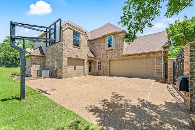 view of front of property with central AC, concrete driveway, roof with shingles, a front yard, and brick siding