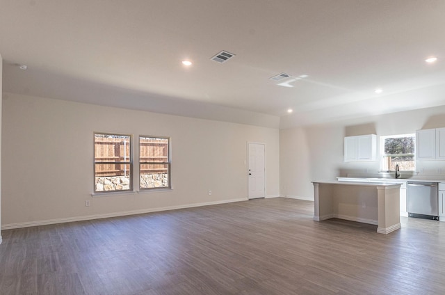 119 Kylie Dr, Cleburne, TX 76031 - interior space featuring stainless steel dishwasher, wood finished floors, a center island, light countertops, and white cabinetry