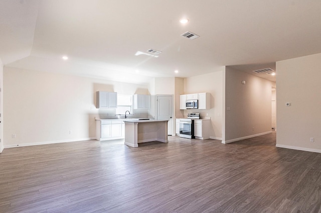 119 Kylie Dr, Cleburne, TX 76031 - unfurnished living room featuring dark wood finished floors, baseboards, recessed lighting, and visible vents