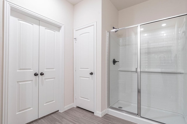 119 Kylie Dr, Cleburne, TX 76031 - full bathroom with baseboards, a stall shower, and wood finished floors
