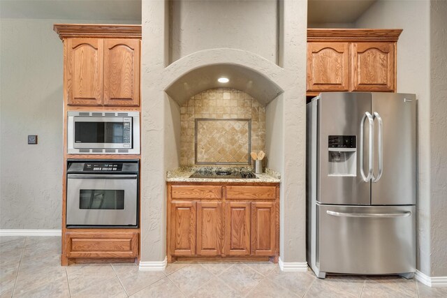 132 Silver Rose Blvd, Burleson, TX 76028 - kitchen with appliances with stainless steel finishes, a kitchen breakfast bar, light stone counters, recessed lighting, and tasteful backsplash