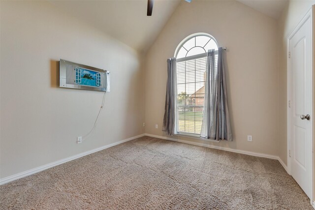 carpeted empty room featuring baseboards, a wall mounted air conditioner, ceiling fan, and lofted ceiling