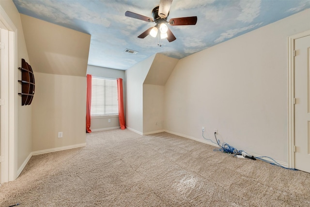 bonus room with carpet floors, visible vents, lofted ceiling, baseboards, and a ceiling fan