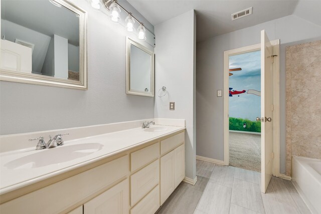 bathroom featuring a sink, double vanity, and visible vents