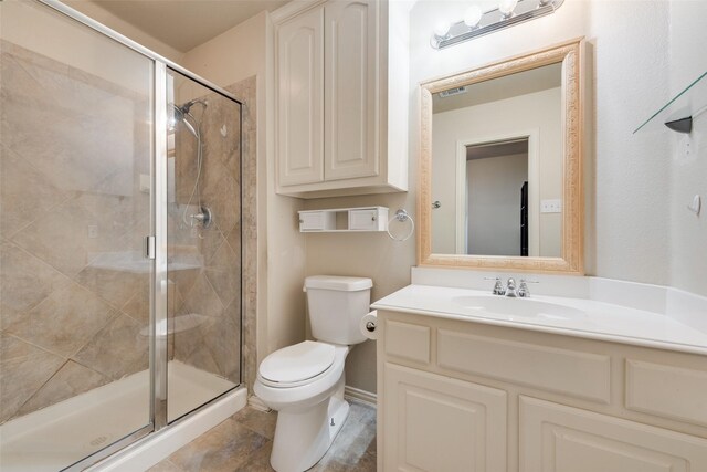 full bathroom featuring visible vents, a stall shower, toilet, and vanity