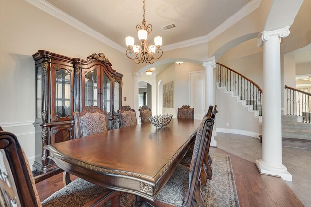 dining room featuring visible vents, ornamental molding, decorative columns, stairway, and arched walkways