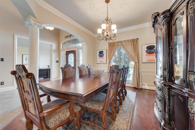 132 Silver Rose Blvd, Burleson, TX 76028 - dining area featuring arched walkways, a chandelier, crown molding, plenty of natural light, and decorative columns