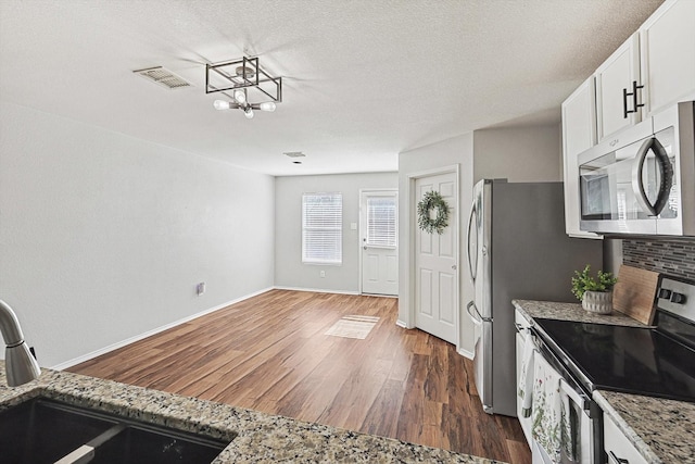 1225 Bellevue Dr, Princeton, TX 75407 - kitchen featuring visible vents, an inviting chandelier, dark wood-type flooring, a sink, and appliances with stainless steel finishes