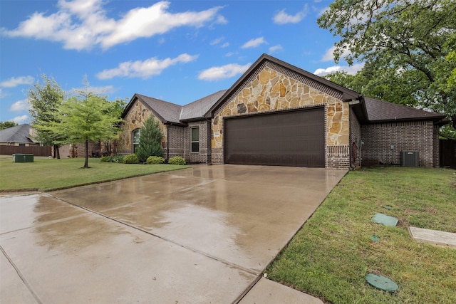 308 Donna Cir, Granbury, TX 76049 - view of front of house with stone siding, a garage, a front lawn, driveway, and brick siding
