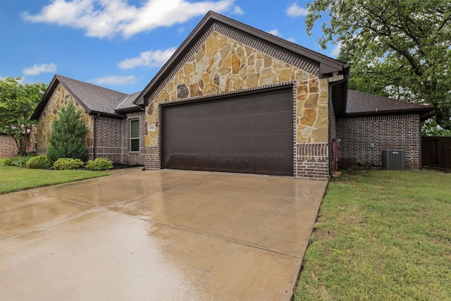 view of front of property featuring a front yard, brick siding, concrete driveway, an attached garage, and stone siding