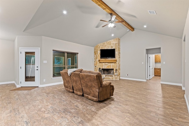 living area with ceiling fan, a stone fireplace, vaulted ceiling with beams, light wood-type flooring, and visible vents