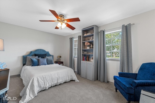 bedroom featuring baseboards, a ceiling fan, and carpet flooring